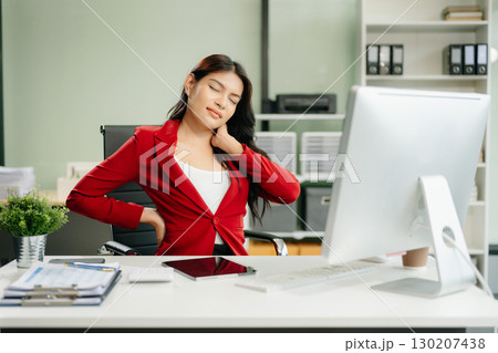 Overworked young Asian businesswoman office worker suffering from neck pain after had a long day Overworked young Asian businesswoman office worker suffering from neck pain after had a long day 130207438