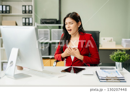 Overworked young Asian businesswoman office worker suffering from neck pain after had a long day 130207448