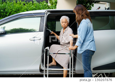 Caregiver help Asian elderly woman disability patient use walker to get in car. Caregiver help Asian elderly woman disability patient use walker to get in car. 130207876