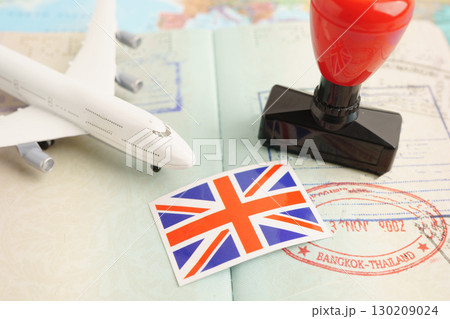 UK United Kingdom passport with approved stamp on document for tourism to immigration at airport in country. 130209024