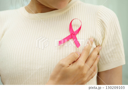 Asian woman with pink ribbon for October world breast cancer day. 130209103
