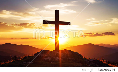 Silhouette of a wooden cross on a hilltop with golden sunset and glowing rays, symbolizing faith, hope, sacrifice, and spiritual peace in a dramatic natural landscape, cross on sunset 130209314