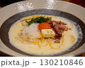 Spaghetti Carbonara with bacon and egg yolk served on a plate. Soft Focus. 130210846