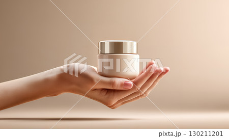 female hand holding cream bottle of lotion 130211201
