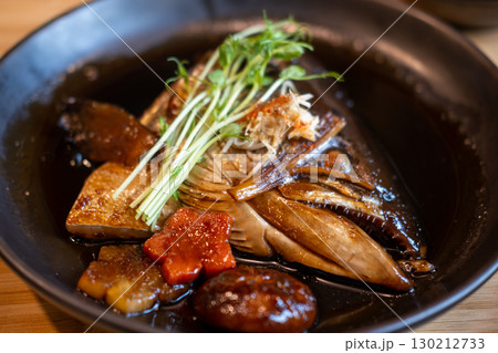 Salmon Kabutoni, a Japanese dish featuring salmon head simmered in a savory, sweet soy sauce. Salmon Kabutoni, a Japanese dish featuring salmon head simmered in a savory, sweet soy sauce. 130212733