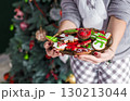 Beautiful Redhead Woman Holding Plate with Cakes 130213044