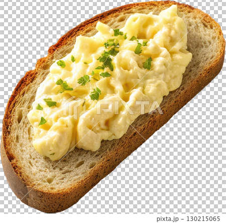 Creamy scrambled eggs with fresh parsley garnish served on a slice of rustic toasted bread 130215065