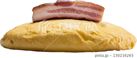 Thick slice of raw cured bacon rests atop a fluffy yellow omelette a hearty breakfast component 130216265