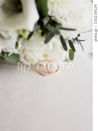 Luxury wedding rings near flowers 130216524