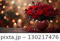Red roses arranged in heart-shaped vase with seasonal berries creating romantic Valentine's Day decoration against warm bokeh background 130217476