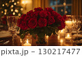 Red roses bouquet with candlelight on elegant table setting, romantic dining atmosphere 130217477