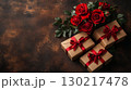Red roses bouquet with elegant gift boxes arranged against rustic background, perfect for romantic celebration and special occasion concept 130217478