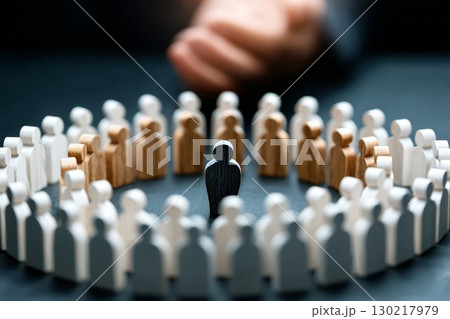 Leadership concept with miniature people standing in a circular structure. Visual metaphor for team strategy and influence. Leadership concept with miniature people standing in a circular structure. Visual metaphor for team strategy and influence. 130217979