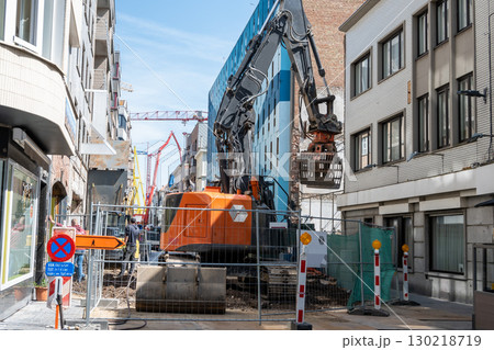 Work during the construction of a building in the city. Excavator and bulldozer for destruction of an old building.  130218719