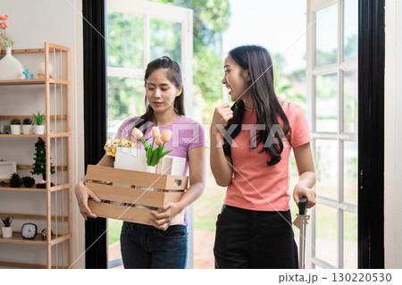 Moving in with friends, carrying flowers and boxes, celebrating new beginnings. Moving in with friends, carrying flowers and boxes, celebrating new beginnings. 130220530