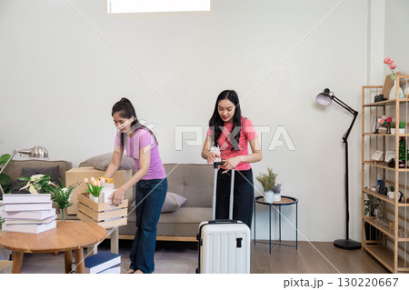 LGBT couple unpacking luggage and organizing their new home together, a joyful relocation experience LGBT couple unpacking luggage and organizing their new home together, a joyful relocation experience 130220667
