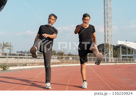 Wellness and fitness for seniors two men exercising on a track. 130220924