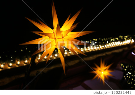 Herrnhut star at night, decoration at the Christmas market, star shaped lamp 130221445