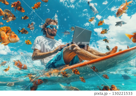 Surfer working on laptop surrounded by colorful fish ocean underwater photography tropical environment aerial view remote work adventure 130221533
