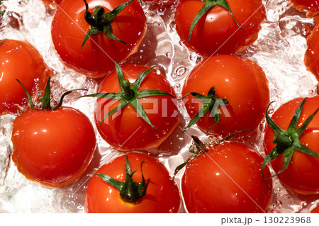 Water Burst Around Fresh Tomatoes Overhead Angle Water Burst Around Fresh Tomatoes Overhead Angle 130223968