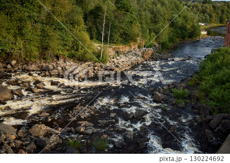 A Serene River Gracefully Flowing Through a Lush and Vibrant Green Landscape, Enhancing Nature A Serene River Gracefully Flowing Through a Lush and Vibrant Green Landscape, Enhancing Nature 130224692
