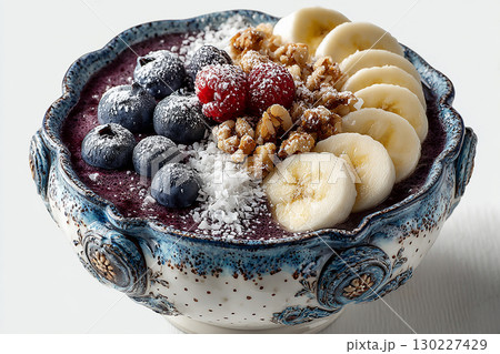 Stylish tableware. Top view. Acai bowl with granola and edible flowers. Hotel Breakfast Styles. Stylish tableware. Top view. Acai bowl with granola and edible flowers. Hotel Breakfast Styles. 130227429