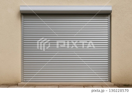 Closed Metallic Security Shutter on Beige Wall 130228570
