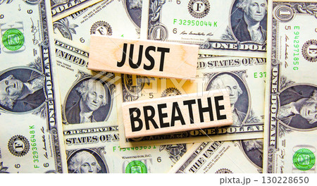 Just breathe and psychological symbol. Concept words Just breathe on beautiful wooden block. Beautiful background from dollar bills. Business psychological and Just breathe concept. Copy space 130228650