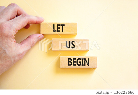 Let us begin symbol. Concept words Let us begin on beautiful wooden blocks. Beautiful white background. Businessman hand. Business motivational let us begin concept. Copy space. 130228666