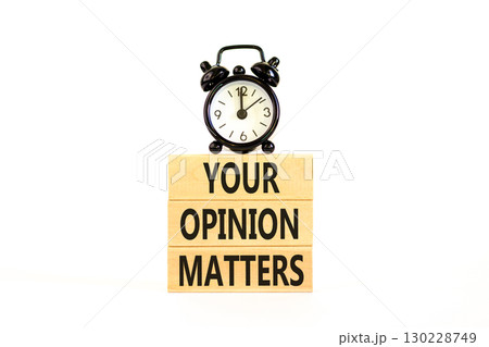 Your opinion matters symbol. Concept words Your opinion matters on beautiful wooden blocks. Beautiful white background. Black alarm clock. Business your opinion matters concept. Copy space. 130228749