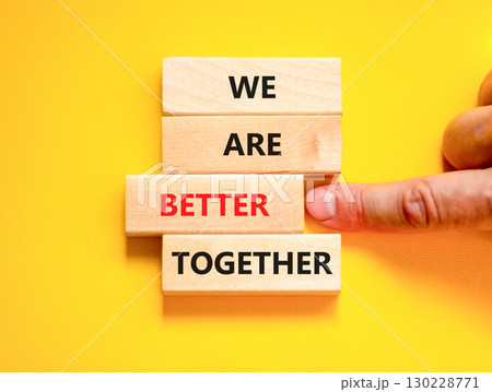 We are better together symbol. Concept words phrase We are better together on beautiful wooden blocks. Beautiful yellow background. Businessman hand. Business We are better together concept Copy space 130228771
