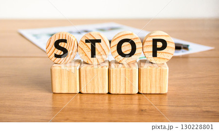 Stop symbol. Concept word Stop on beautiful wooden circles on wooden blocks. Beautiful wooden table white background. Business, lifestyle, support and stop concept. Copy space. Stop symbol. Concept word Stop on beautiful wooden circles on wooden blocks. Beautiful wooden table white background. Business, lifestyle, support and stop concept. Copy space. 130228801
