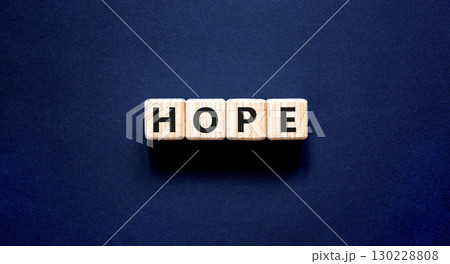 Hope symbol. Concept word Hope on beautiful wooden blocks. Beautiful black table black background. Business, lifestyle, support and hope concept. Copy space. 130228808