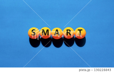 Smart symbol. Concept word Smart on beautiful yellow tennis ping pong balls. Beautiful wooden table wooden background. Business lifestyle smart concept. Copy space. 130228843