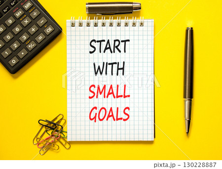 Start with small goals symbol. Concept words phrase Start with small goals on beautiful note. Black pen. Calculator. Beautiful yellow background. Business Start with small goals concept. Copy space Start with small goals symbol. Concept words phrase Start with small goals on beautiful note. Black pen. Calculator. Beautiful yellow background. Business Start with small goals concept. Copy space 130228887
