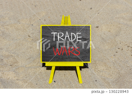 Trade wars symbol. Concept word Trade wars on beautiful black blackboard. Beautiful sand beach background. Black blackboard. Business trade wars concept. Copy space. Trade wars symbol. Concept word Trade wars on beautiful black blackboard. Beautiful sand beach background. Black blackboard. Business trade wars concept. Copy space. 130228943