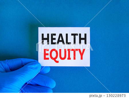 Health equity symbol. Concept words Health equity on beautiful white card. Doctor's hand in blue medical glove. Beautiful blue background. Medical healthy lifestyle health equity concept. 130228973