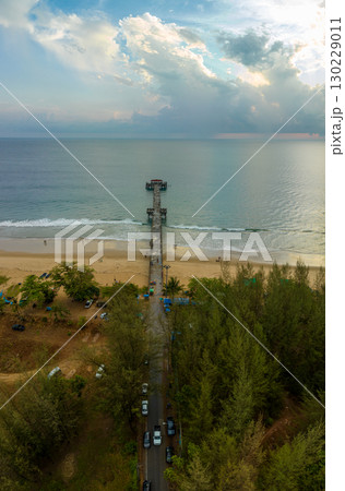 aerial view The bridge extends into the blue sea at sunset. 130229011