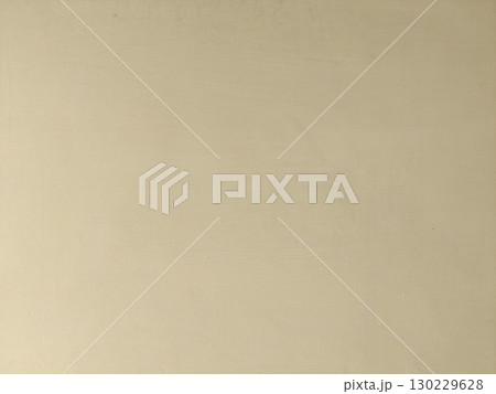 Close up of beige wall with subtle cracks and imperfections showing texture 130229628