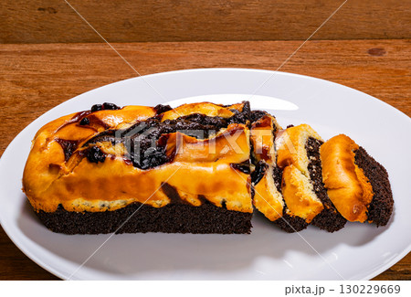 Closeup of blueberry cheese brownie in white ceramic plate. Closeup of blueberry cheese brownie in white ceramic plate. 130229669