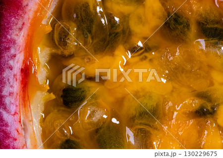 Extreme closeup view of juicy pulp and seeds of ripe passion fruit. Extreme closeup view of juicy pulp and seeds of ripe passion fruit. 130229675