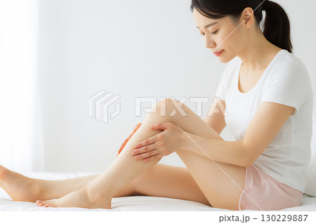 脚をケアする日本人女性のボディマッサージ風景 130229887