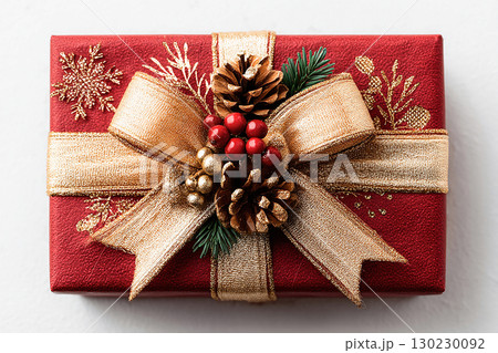 Present for celebration. Classic Red Gift Box with Gold bow on white background. Christmas decor. 130230092