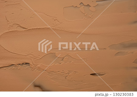 The texture of foundation on a beige background. 130230383