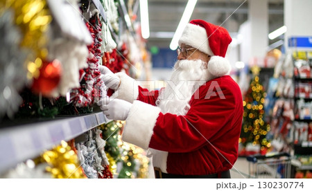 Santa selects festive decorations in the supermarket aisles ahead of the Christmas holidays 130230774