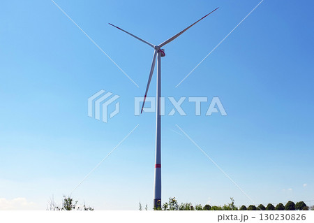 Big white windmill and nature background. Wind turbine for alternative green energy in Europe. Big white windmill and nature background. Wind turbine for alternative green energy in Europe. 130230826