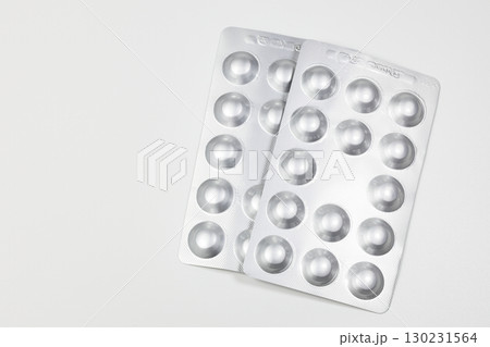 Medical drugs and pills in silver shiny package isolated on white background. Medical drugs and pills in silver shiny package isolated on white background. 130231564