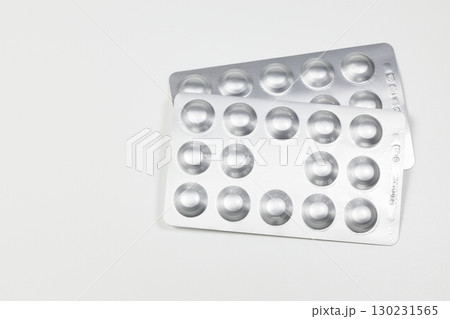 Medical drugs and pills in silver shiny package isolated on white background. 130231565