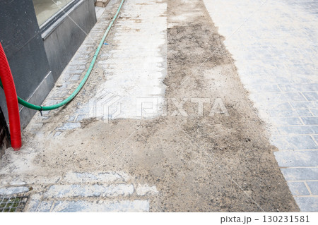 Road renovation repair in big city. Construcion site of pavement cobbleston street. Roadworks stonework at pedestrian area. Urban development 130231581