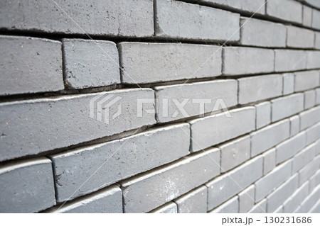 Gray structural stone wall of the ancient building consists of bricks. Nature structural background. 130231686